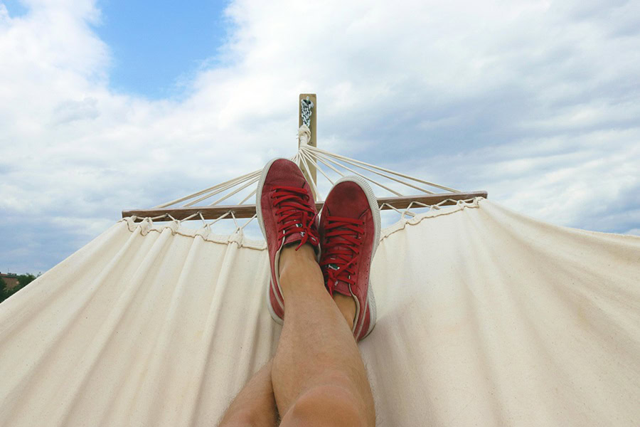 Best Quotes for National Relaxation Day #NationalRelaxationDay View of a Person's Legs and Feet in a Hammock