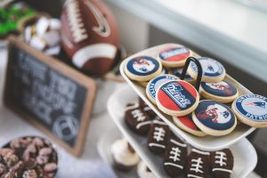 Super Bowl Party Food Overhead View of Cookies with Team Logos on Them and Football Themed Decorations